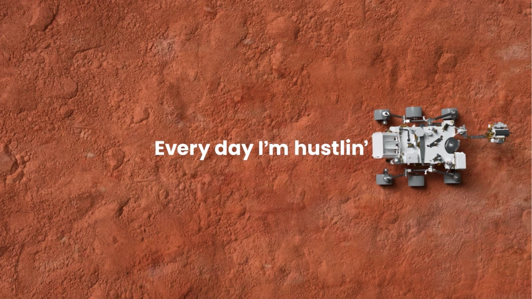 Mars rover on red planet surface with text: "Every day I'm hustlin'.